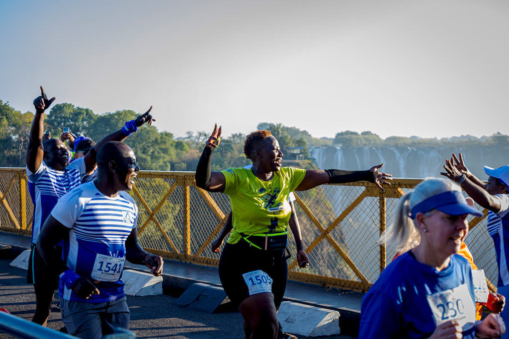 Running across the Victoria Falls Bridge with the falls in the background