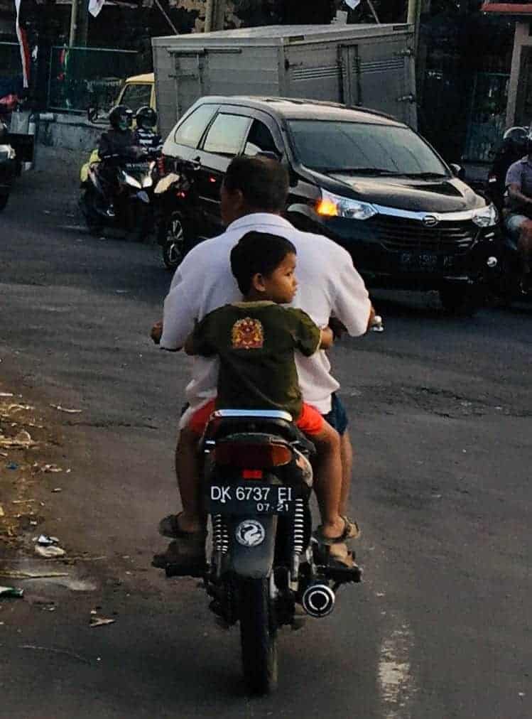 Man and boy on motorbike in Bali