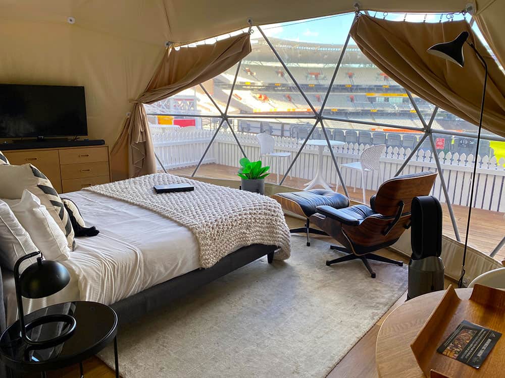 View of bed and stadium in glamping pod