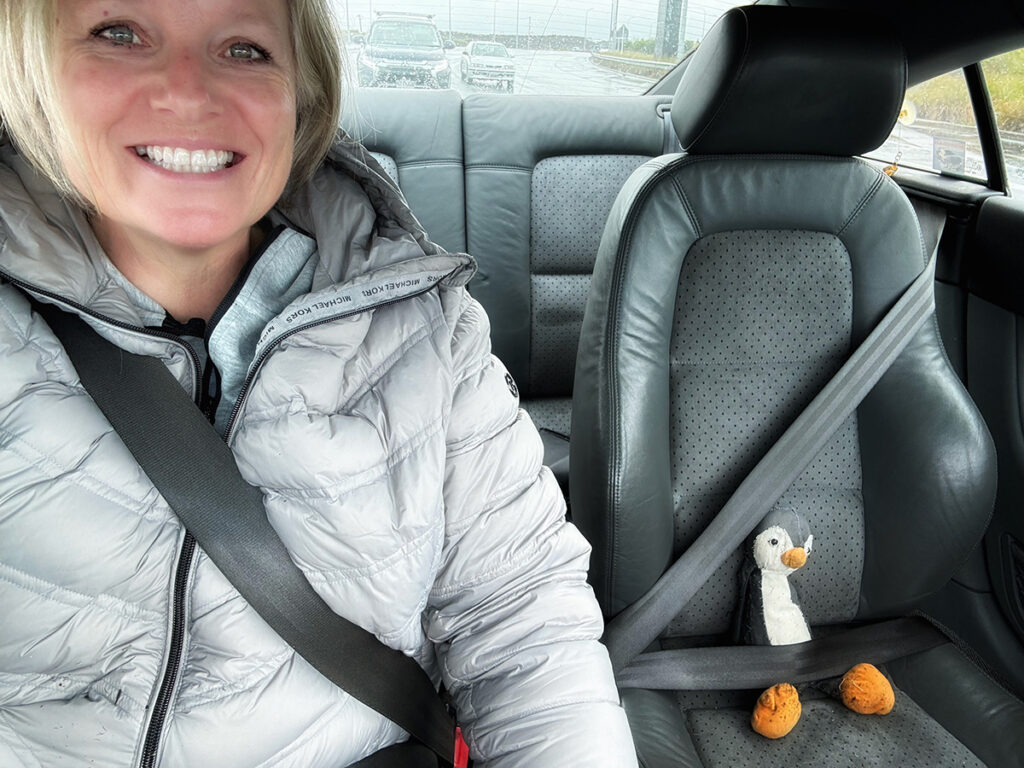 Megan in car with toy penguin
