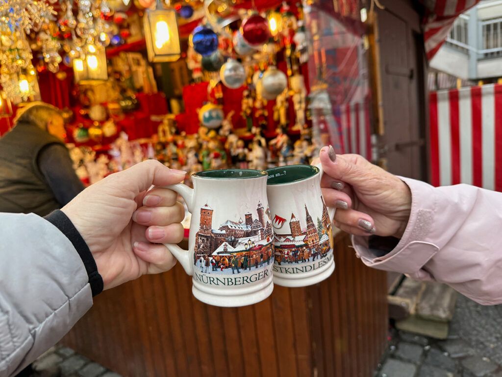 Cheers with Christmas mugs in Germany