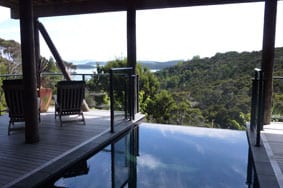 The Sanctuary's infinity pool overlooking the green landscapes and the distant seas.