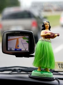 A miniature hula girl placed on the front car near the GPS gadget.